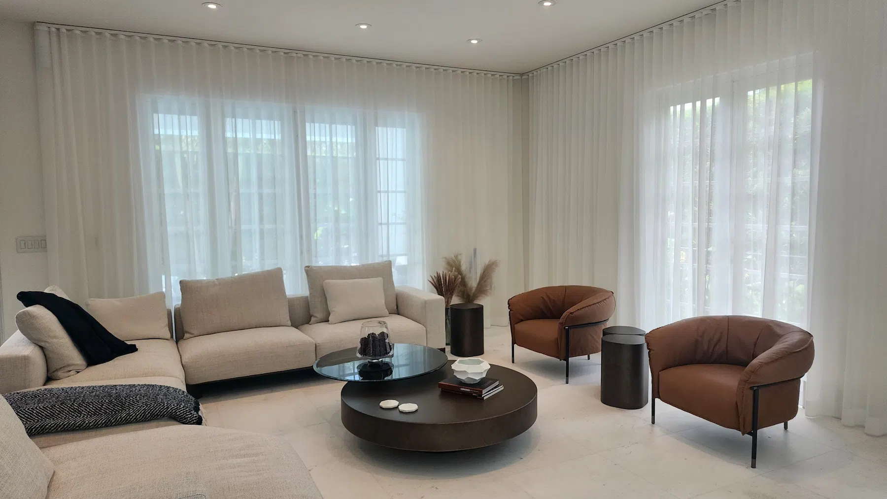 Contemporary living room featuring custom window shades and blinds, blending style and functionality for a perfect home environment.