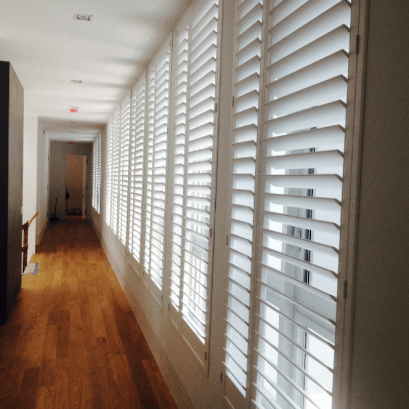 Explore premium Norman plantation shutters for windows, perfect for achieving a sophisticated look.